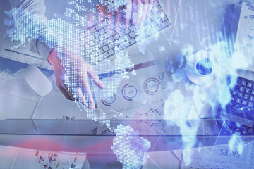 Multi exposure of man's hands typing over computer keyboard and forex graph hologram drawing. Top view. Financial markets concept.
