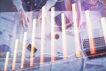 Double exposure of man and woman working together and financial chart hologram drawing. market...