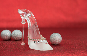 Shoe made of glass on the red background.