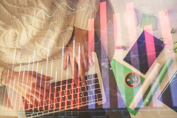 Multi exposure of woman hands working on computer and forex chart hologram drawing. Top View. Financial analysis concept.