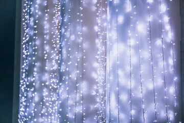 Naklejka na ściany i meble Christmas background with garland. Christmas lights, street LED garland