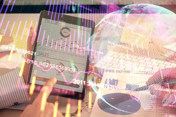 Multi exposure of man's hands holding and using a phone and financial chart drawing. Market...