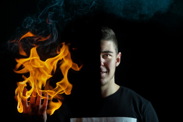 A portrait of a guy holding fire in right hand, (Half face portrait.