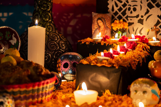Colorful skull on colorful traditional Day of the Dead "ofrenda"