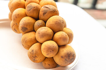 fresh longkong fruit asia closeup lies on a white background