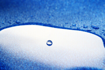 close up of water droplet on blue surface