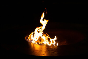 bright orange flame burns in the dark decor colorful