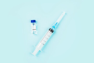 Flat lay of coronavirus covid-19 vaccine with syringe, face mask. Mockup with copy space, top view,...