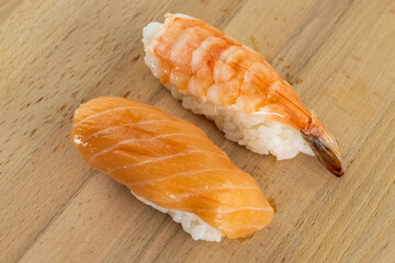 sushi with salmon and shrimp set Japanese food lies on a wooden background