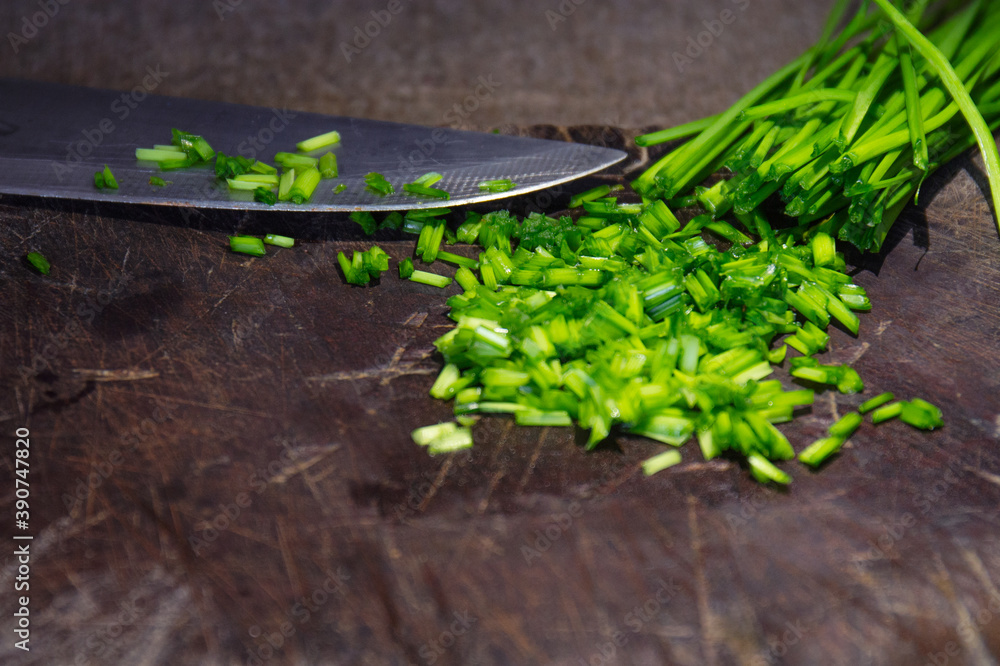 Canvas Prints Top view of sliced onion chives on a wooden chopping board