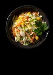 Coleslaw placed on a pitch-black background