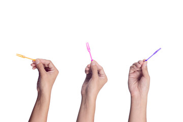 Set of Hand holding Colorful Plastic skewers isolated on white background.