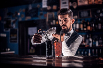Bartender makes a cocktail in the public house