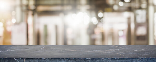 Empty black marble stone table top and blur glass window interior shopping mall banner mock up abstract background - can used for display or montage your products.