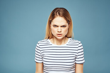 Fototapeta premium Upset woman emotions displeasure gestures with hands blue background