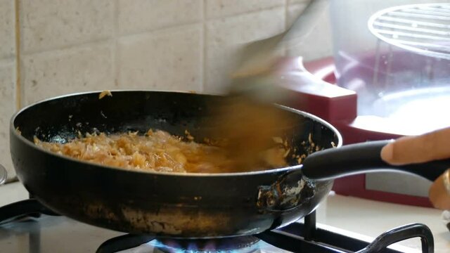 Finely chopped garlic being fried in a pan