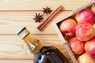 Apple vinegar or cider with cinnamon on wooden table hackground. Top view. Flat lay.