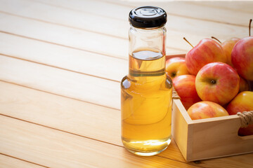 Apple vinegar or cider on wooden table hackground.