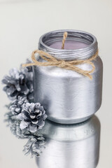 Obraz na płótnie Canvas New's year image. Christmas candle in silver color with fir cones. High quality photo