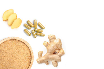 Ginger powder capsule, ginger rhizome with slice and powder on wood.
