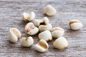 White Job's tears ( Adlay millet or  pearl millet ) isolated on wood table background. Macro