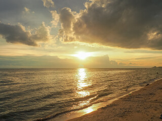 Evening atmosphere at Wonnapa Beach The golden light of the sun glitters on the sea.