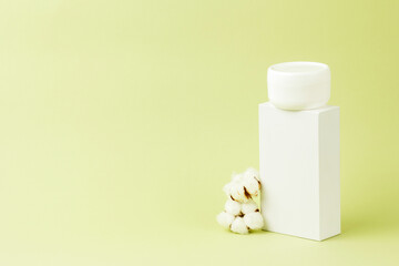 Blank white plastic container for cream, lotion, nourishing or moisturizing mask. Eco-friendly, organic cosmetology,cotton flowers