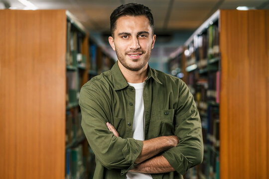 Portrait of Asian young Student in casual suit  in library of university or college over book shelf background, learning and education, Back to school and university concept