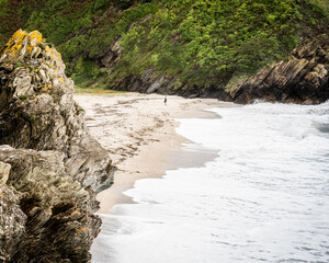 Watching The Waves Crash Against The Beach In cornwall
