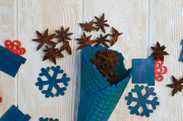 spices anise in a waffle cone with copy space text top view and christmas decor