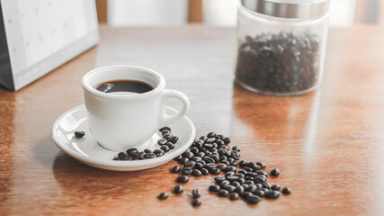 Coffee cup and saucer on a wooden table. Dark background.