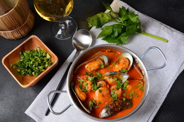 French seafood bouillabaisse soup/fish stew with mussels served with garlic toast baguette