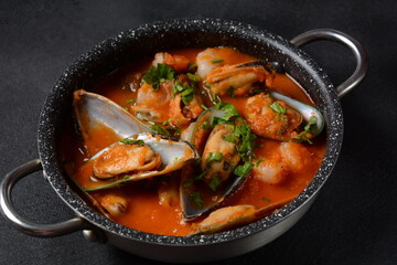 French seafood bouillabaisse soup/fish stew with mussels served with garlic toast baguette
