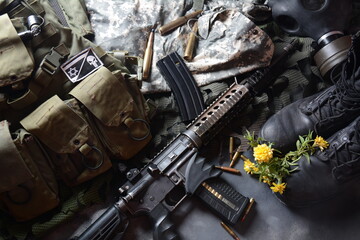 Assault rifle (M4A1)  with ammunition on camouflage uniform,and military equipment for army,bullets and a magazine