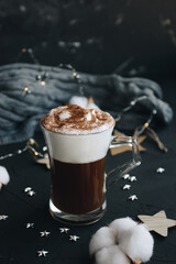 Coffee, cotton and gray sweater on a dark background. Cozy home concept.