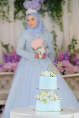 Fototapeta na wymiar Bride wearing baby blue Malay traditional cloth pose during wedding celebration in Malaysia