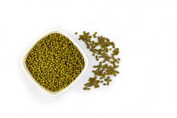 Mung beans in ceramic bowl isolated on white background, top view