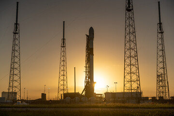 SpaceX Falcon 9 rocket on the launchpad at sunset - Powered by Adobe