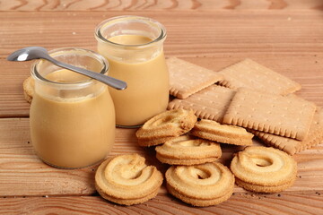 Milk pudding dessert in jar and cookies