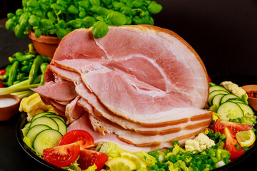 Sliced ham with fresh salad close up.