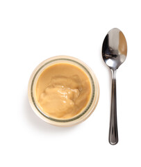 Milk pudding dessert in jar with spoon. Isolated with clipping p