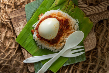 Simple Traditional popular Malaysian Nasi Lemak served on a banana leaf