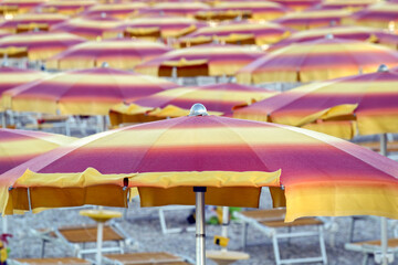 Fototapeta na wymiar Alignement de parasols sur une plage en Italie