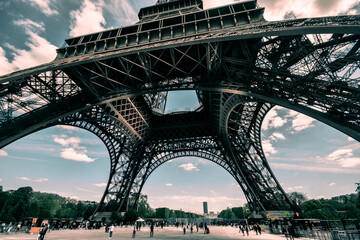 people walking under the Eiffel Tower
