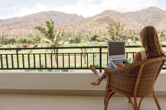 Back View Happy Confident Woman Using Laptop While Sitting On Balcony And Working From Home