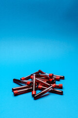 top view of medicine test tubes with blood samples over blue background