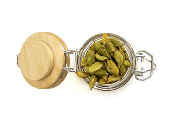 Top view on isolated cardamom seeds in a glass jar