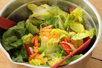 a bowl of fresh green lettuce and tomatoes