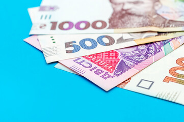 Different ukrainian banknotes on blue background.