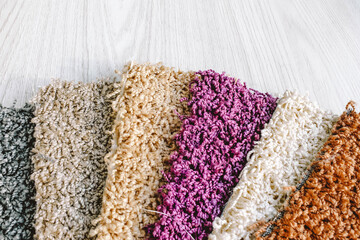 Samples of carpet with a long pile in a bundle.